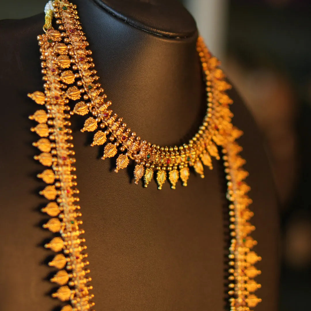Gold necklace on a black mannequin with a blurred background