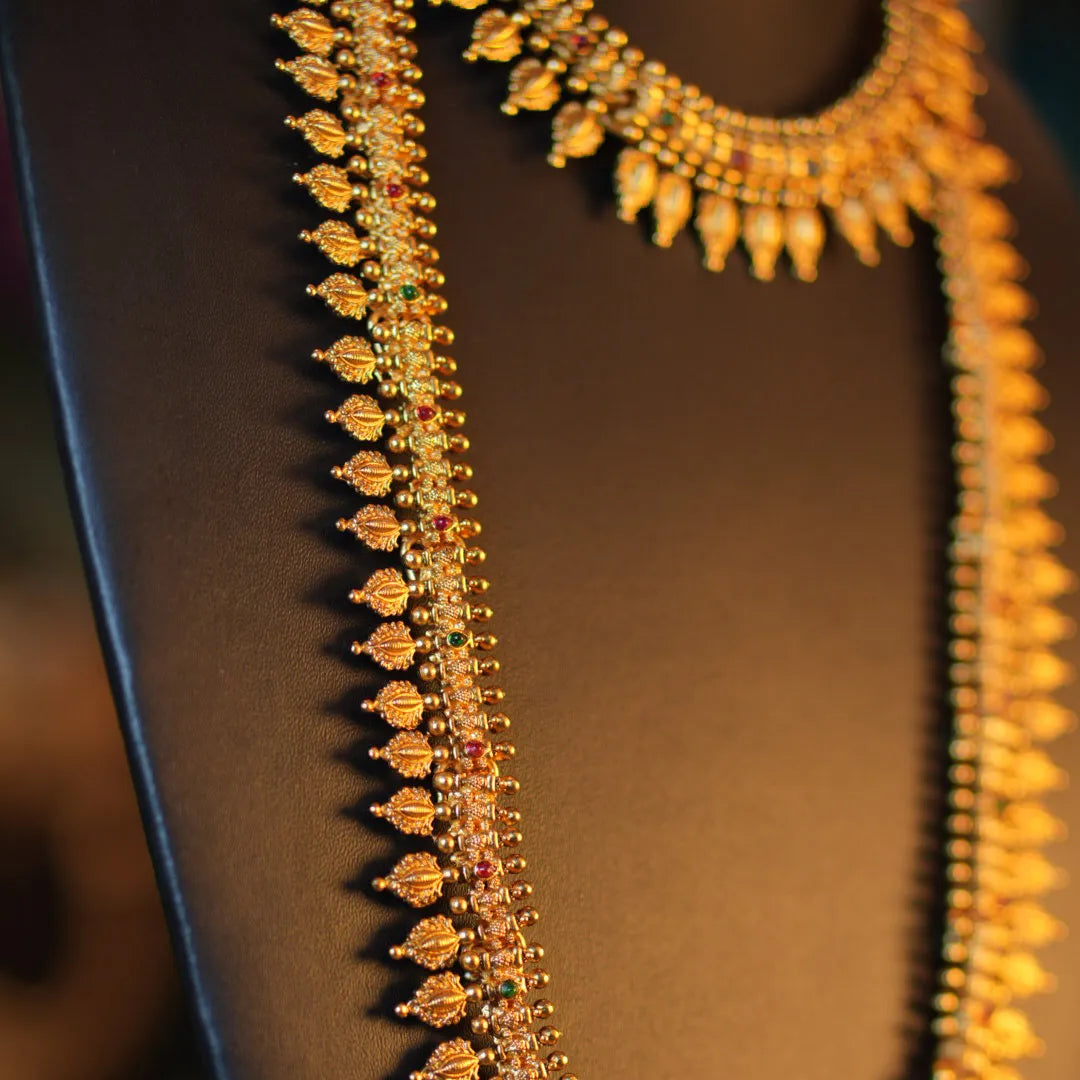 Gold necklace on a mannequin with a blurred background
