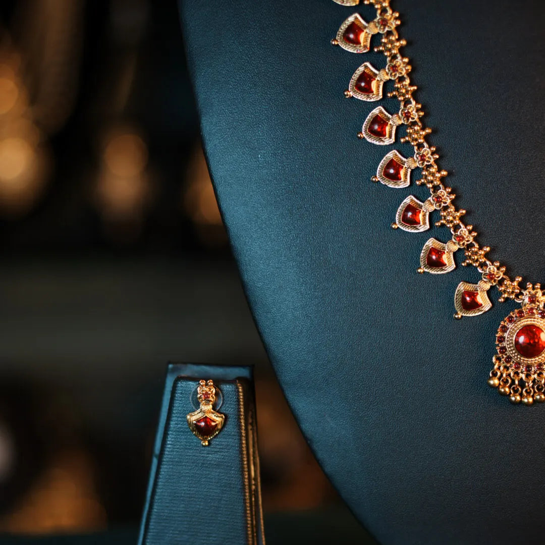 Jewelry set with a necklace and earring on a dark background