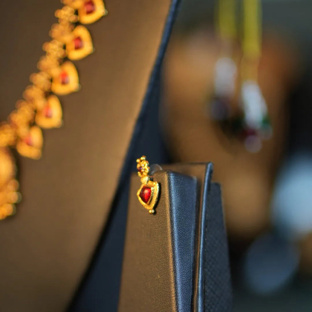 Close-up of a handbag with decorative elements on a blurred background