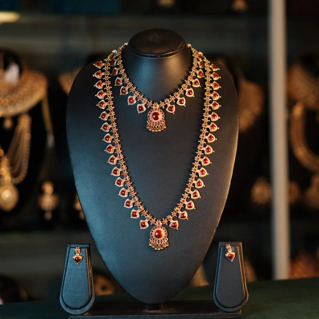 Ornate necklace on a mannequin bust with a blurred jewelry store background