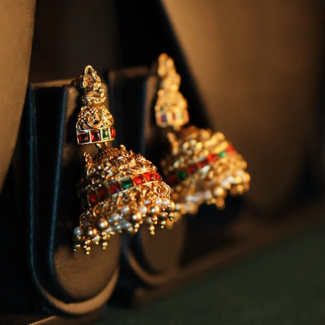 Decorative earrings with gemstones on a dark background