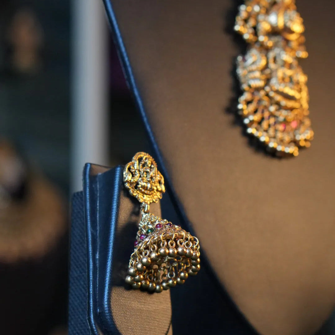 Gold earrings on a dark background