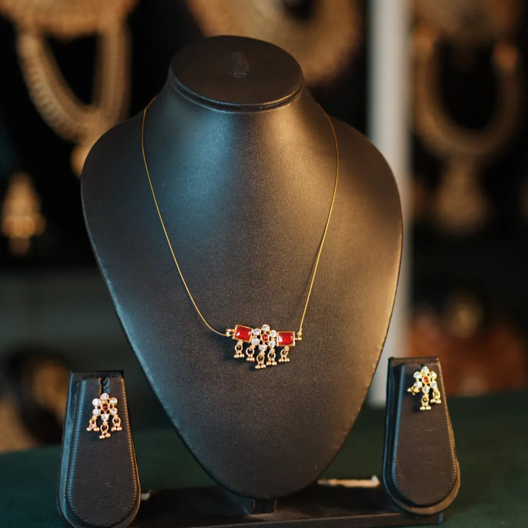 Jewelry set on a black mannequin bust with blurred background
