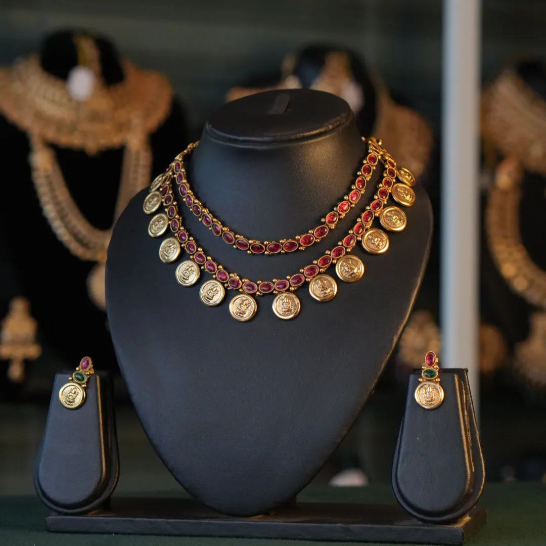 Jewelry set on a black mannequin bust with blurred background