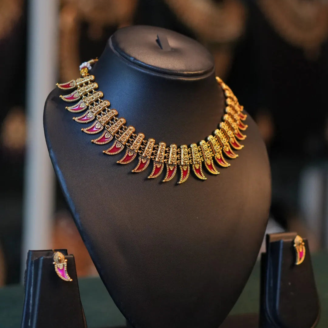 Gold necklace on a black mannequin bust with a blurred background