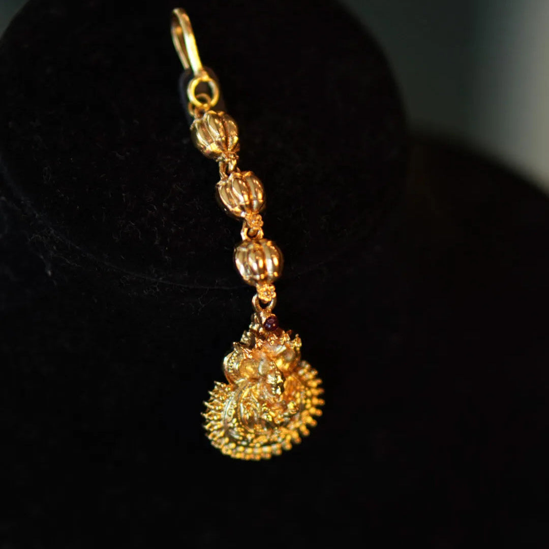 Gold earring on a black background