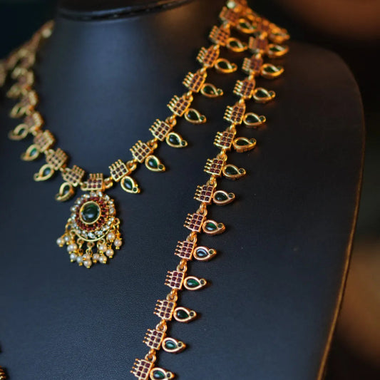 Gold necklace on a blue mannequin with a blurred background