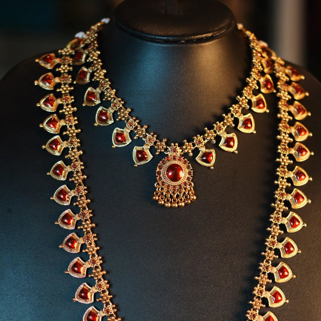 Ornate necklace with red gemstones on a mannequin