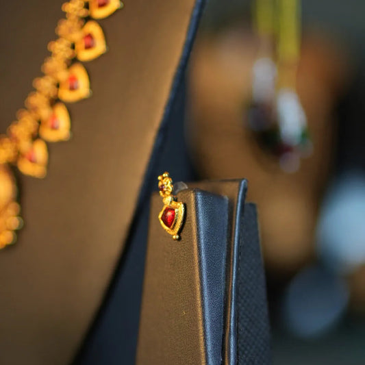 Close-up of a decorative shoe with heart-shaped embellishments on a blurred background