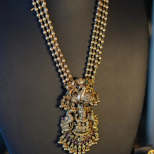 Decorative necklace with intricate design on a mannequin bust