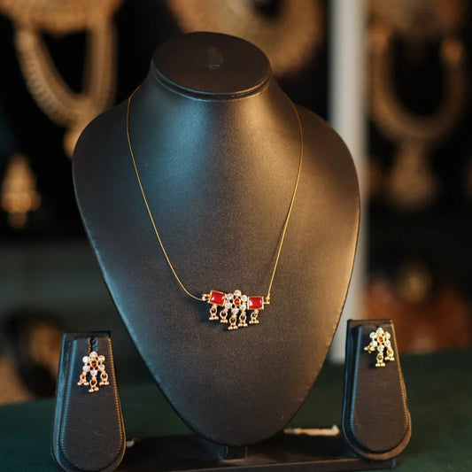 Jewelry set on a black mannequin bust with blurred background