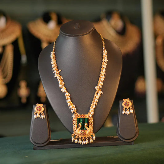 Jewelry set on a mannequin bust with a blurred background