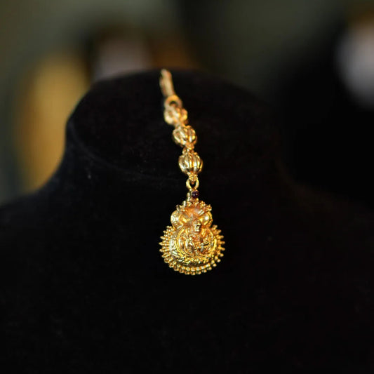 Gold necklace with a pendant on a black background