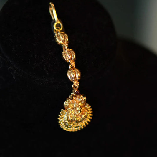 Gold earring on a black background