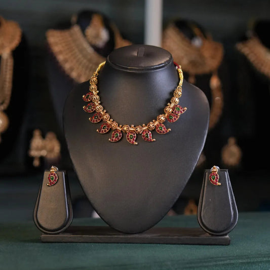 Jewelry set on a black stand with a blurred background