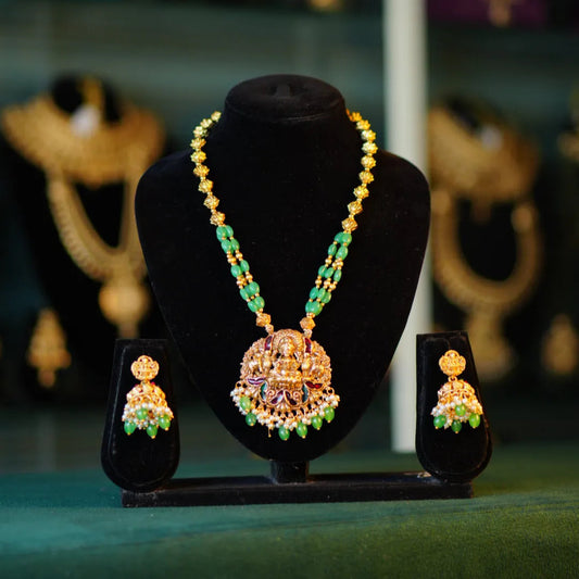 Jewelry set on a black stand with a blurred background